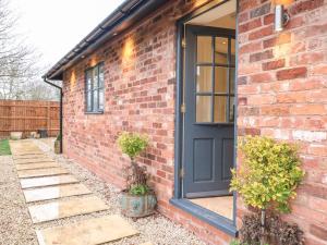 a brick house with a black door at Walnut View in Rugeley