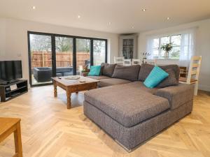 a living room with a couch and a table at Walnut View in Rugeley