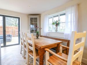a dining room with a wooden table and chairs at Walnut View in Rugeley