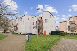 a row of white buildings in a park at Budget spacious apart with terrace in Mantes-la-Jolie