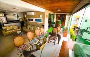 ein Wohnzimmer mit einer Couch und einem Tisch und Stühlen in der Unterkunft FLAT MURO ALTO Manihi1101 in Porto De Galinhas