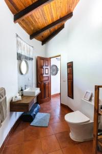 a bathroom with two sinks and a toilet at SoulShine in Playa Avellana