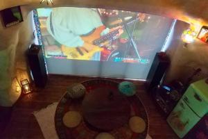 an overhead view of a tv with a guitar on it at 土と音の旅チオンの家 in Onna