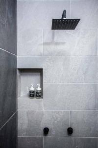 a bathroom with a shower with two soap bottles at Incredible Apartment Avándaro in Valle de Bravo
