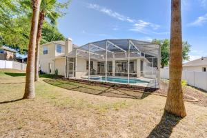 a home with a glass house with a swimming pool at Stunning Minneola Home with Private Pool and Yard! in Minneola