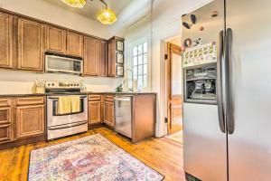 a kitchen with wooden cabinets and stainless steel appliances at Historic Home Near Downtown Little Rock! in Little Rock