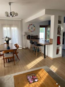 a living room with a table and a dining room at Villa Hélios in Canet-en-Roussillon +31 photos