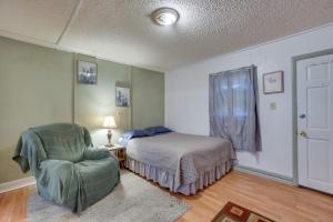 a bedroom with a bed and a chair at Pet-Friendly Loveland Studio Near Boyd Lake! in Loveland