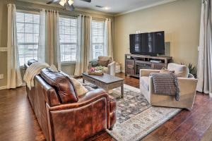 a living room with leather furniture and a flat screen tv at Fayetteville Home Near University of Arkansas! in Fayetteville