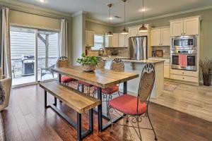 a kitchen with a wooden table and chairs at Fayetteville Home Near University of Arkansas! in Fayetteville