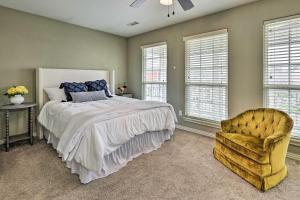a bedroom with a bed and a chair and windows at Fayetteville Home Near University of Arkansas! in Fayetteville
