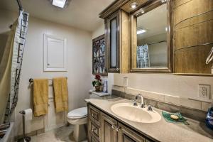a bathroom with a sink and a toilet and a mirror at Serene Creekside Sheridan Getaway Mountain Views! in Sheridan +22 photos