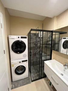 a bathroom with a washer and dryer next to a sink at Ataşehir in Istanbul