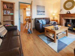 a living room with a couch and a table at Elf Cottage in Heacham