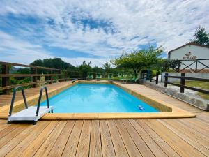 a large swimming pool on a wooden deck at B&B Lao in Papasidero