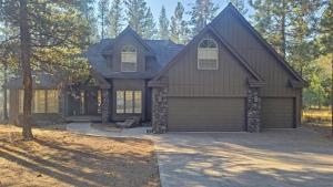 a house with a garage in a yard at Mt. Hood 06 in Sunriver