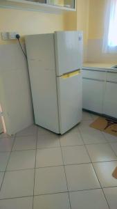 cocina con nevera blanca en una habitación en Inviting 3-Bed Apartment in Nairobi en Nairobi