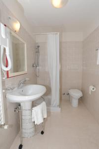 a bathroom with a sink and a shower and a toilet at Startermini in Rome