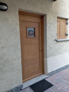 a wooden door of a building with a painting on it at THE LITTLE NEST in Valdisotto