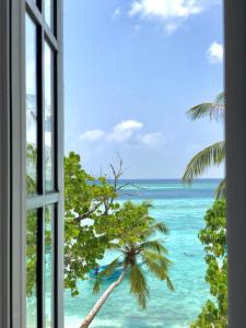 an open window with a view of the ocean at Aqua Sunset in Gulhi