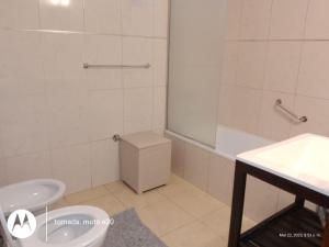 a bathroom with a toilet and a sink at DEL SOL APART TERMAL II in Termas de Río Hondo