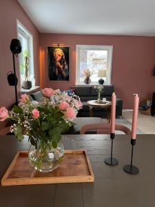 a living room with a vase of flowers on a table at Drømmefabrikken in Bleik