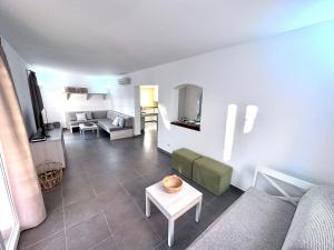 a living room with a couch and a table at VILLA BLANCA in Cala Ferrera