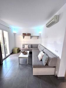 a living room with a couch and a table at VILLA BLANCA in Cala Ferrera