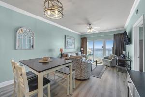 a dining room and living room with a table and chairs at Crystal Tower Unit 908 in Gulf Shores