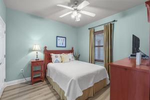 a bedroom with a bed and a ceiling fan at Crystal Tower Unit 908 in Gulf Shores