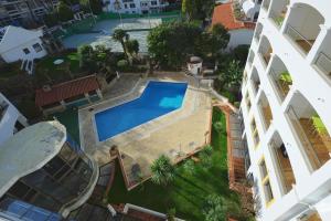 widok na basen pomiędzy dwoma budynkami w obiekcie Clube do Lago Hotel w mieście Estoril