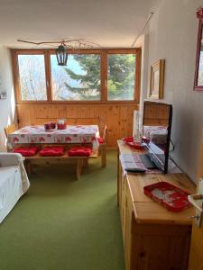 a room with two beds and a table and a bed at Residence “I Larici” Folgarida in Folgarida
