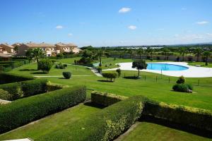 a view of a garden with a swimming pool at El Balcón del Novo -Novo Sancti Petri- Luxury 3 Bedrooms - Piscina y Pista Padel in Chiclana de la Frontera