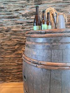 a barrel with bottles of beer sitting on top of it at La Ptit Marie in Houffalize