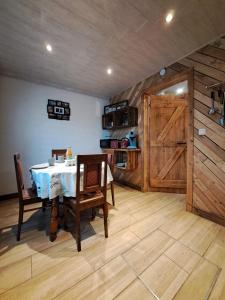 a dining room with a table and a barn door at La Ptit Marie in Houffalize