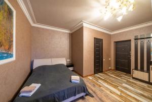 a bedroom with a bed and a chandelier at Aurora Villas in Dilijan