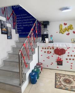 a staircase with red hearts on the wall at Hotel la Sierra Riohacha II in Ríohacha