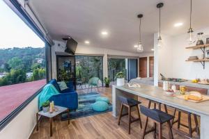 a kitchen and living room with a large window at PH with Panoramic View and Pool in Valle de Bravo