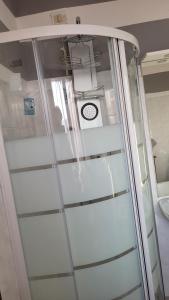 a glass door in a room with a clock at Casa vacanze in Mombarcaro +44 photos