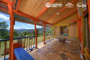 a house for sale in the ozarks with a covered porch at El Artesano in Ramiriquí