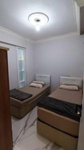 two beds in a small room with a ceiling at The unit beside historical elevator in Konak