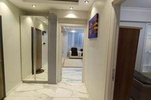 a hallway with a mirror and a living room at The unit beside historical elevator in Konak