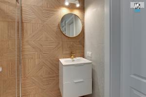 a bathroom with a sink and a mirror at MS Apartments Rest 2.0 in Sopot