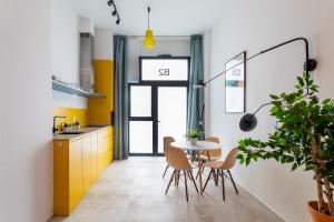 a kitchen with a table and chairs and a yellow cabinet at CHARMING LOFT IN RUZAFA, SOHO b2 in Valencia