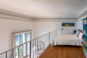 a bedroom with a bed and a balcony at Villa Selva Luxury Lakeview Apartment in Ghiffa