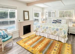 a bedroom with a large bed and a fireplace at Baywatch Cottage in Captiva +14 photos