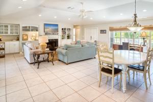 a living room with a table and a dining room at Baywatch Casa home in Captiva