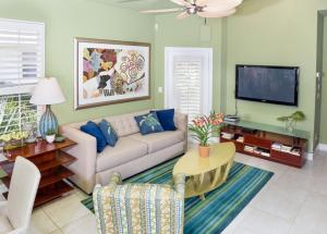 a living room with a couch and a tv at Conch-Captiva Beach Villas in Captiva