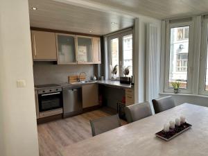 a kitchen with a table and some chairs and a kitchen with a tableablish at "A Cabana" in De Panne in De Panne