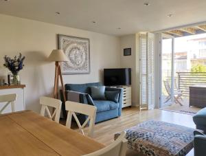 sala de estar con sofá azul y TV en Wild Sands Next to Beach ✩ Cinema ✩ Living Roof ✩ Games Room, en Camber